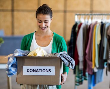 Young woman with donation box in the office