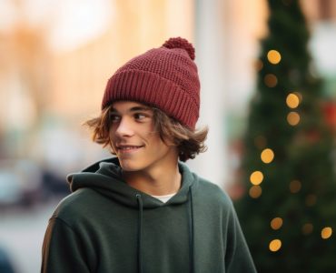 a close up of a person wearing a cotton Beanie, pine color scheme, streetwear holiday vibes, simple, blurred background --ar 3:2
