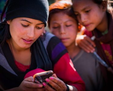 Woman and children looking at phone, Kailah, Bajhang District, Nepal, October 2017.

More:

 Original public domain image from Flickr