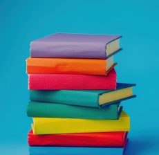 photo shoot of a *stack of colorful books* on a blue background, with no text on it. representing education and knowledge. The books are arranged overlaping, professional photo, minimal and clean --v 6.0 --ar 3:2