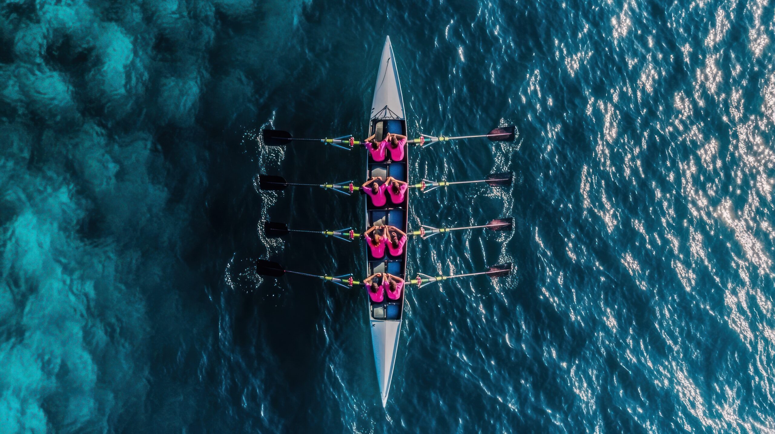 Rowing team in a boat sports water surface.