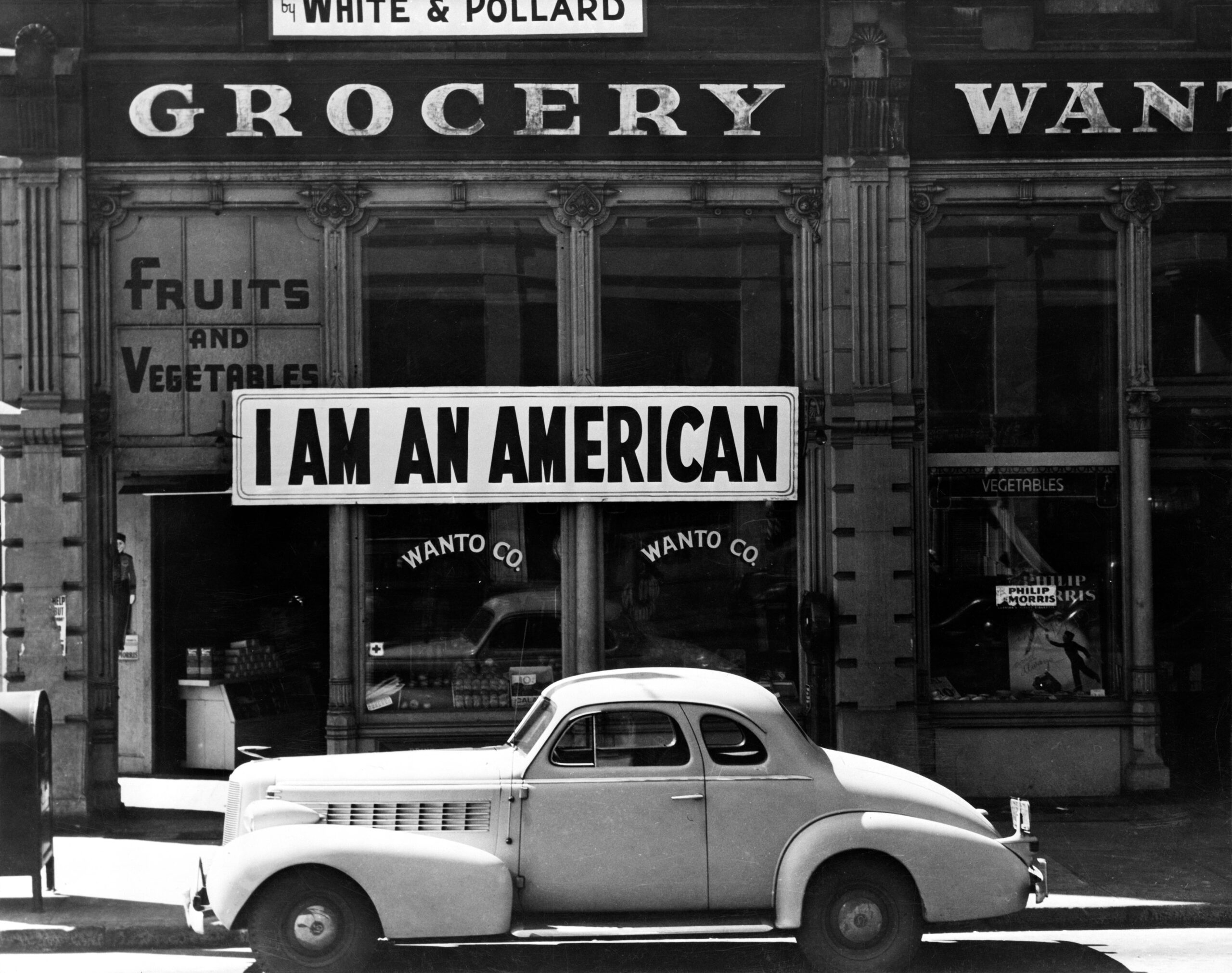 Oakland, Calif., Mar. 1942. A large sign reading "I am an American" placed in the window of a store, at [401 - 403 Eighth] and Franklin streets, on December 8, the day after Pearl Harbor. The store was closed following orders to persons of Japanese descent to evacuate from certain West Coast areas. The owner, a University of California graduate, will be housed with hundreds of evacuees in War Relocation Authority centers for the duration of the war by Dorothea Lange.More: View public domain image source here