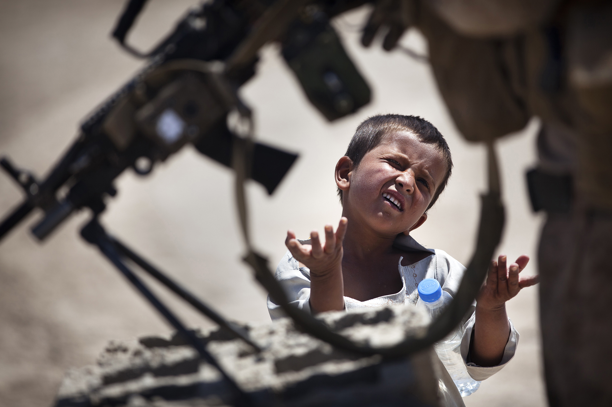 Candy Man

More:

 An Afghan boy petitions Lance Cpl. Christopher Bones, a rifleman with India Company, 3rd Battalion, 3rd Marine Regiment, and 21-year-old native of Brookings, Ore., for candy after receiving a water bottle from another Marine during a security patrol here, April 28, 2012. On the patrol, the Marines gave a battlefield tour of the Safar region to their replacements with Kilo Company, 3rd Battalion, 8th Marine Regiment. After arriving in Helmand province's Garmsir district in October 2011, the 'America's Battalion' Marines are nearing the end of their seven-month deployment. During the deployment, they aided Afghan National Security Forces in assuming lead security responsibility of Garmsir, developing and expanding legitimate Afghan governance by defeating insurgent forces and securing the people of Garmsir.(U.S. Marine Corps photo by Cpl. Reece Lodder). Original public domain image from Flickr