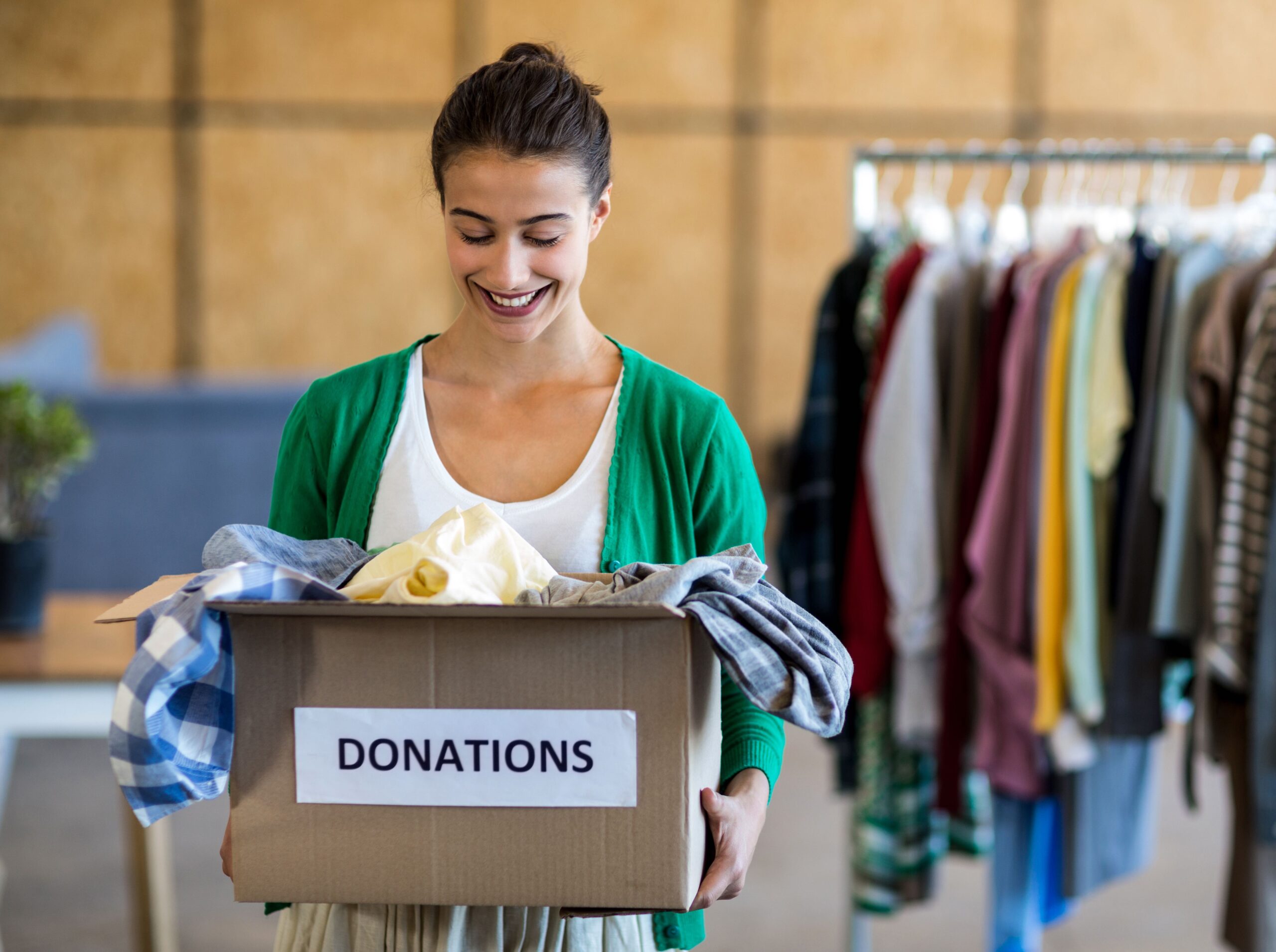 Young woman with donation box in the office